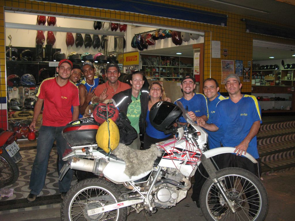 Women Who Ride Motorcycles: Stopped in Brazil for a battery. An image of a Honda XL surrounded by Cristi and some mechanics.