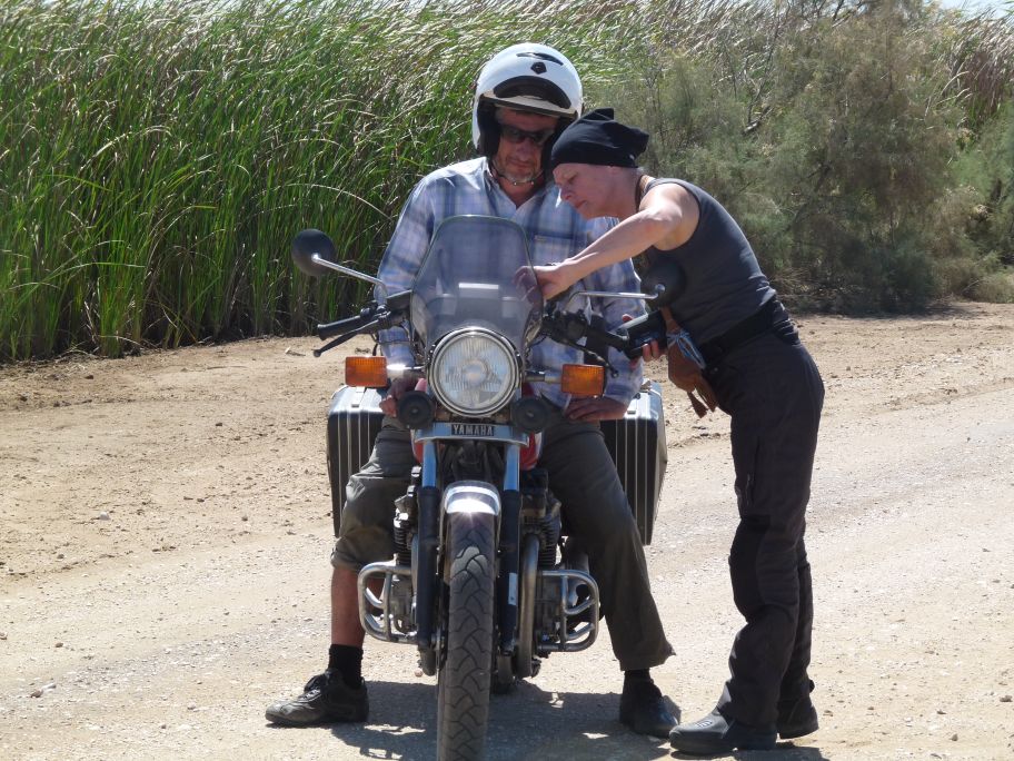 Women Who Ride: Dutch rider Elizabeth teaches a man how to ride near the Senegal border