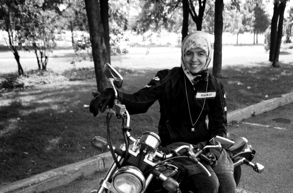 Khadijah Vakily, a Canadian Muslimah on a motorcycle, poses with her Honda Rebel