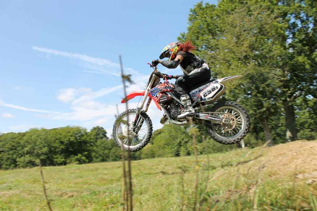 Women Who Ride: Nimisha Patel doing a jump on her MX bike