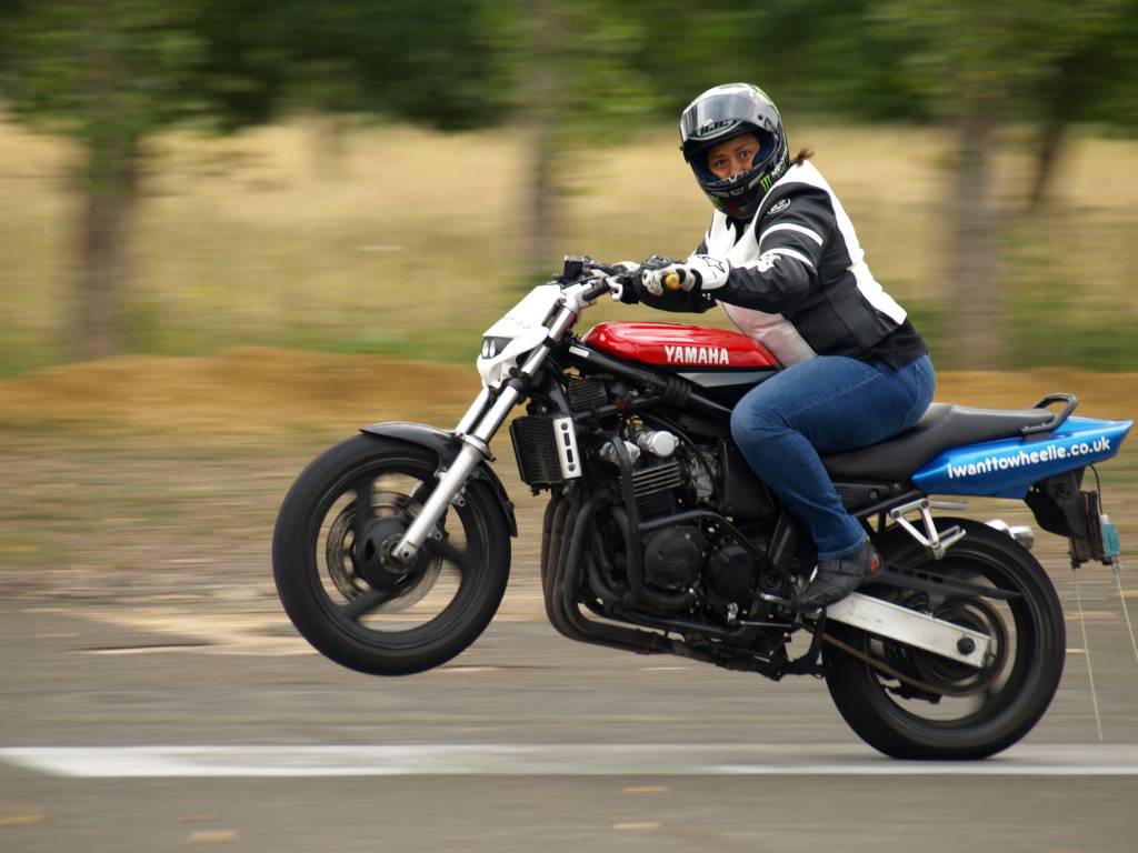 Women Who Ride: Sherrie Woolf popping a wheelie